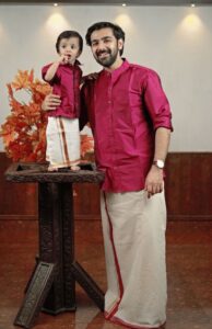 father and son wearing family matching traditional outfits