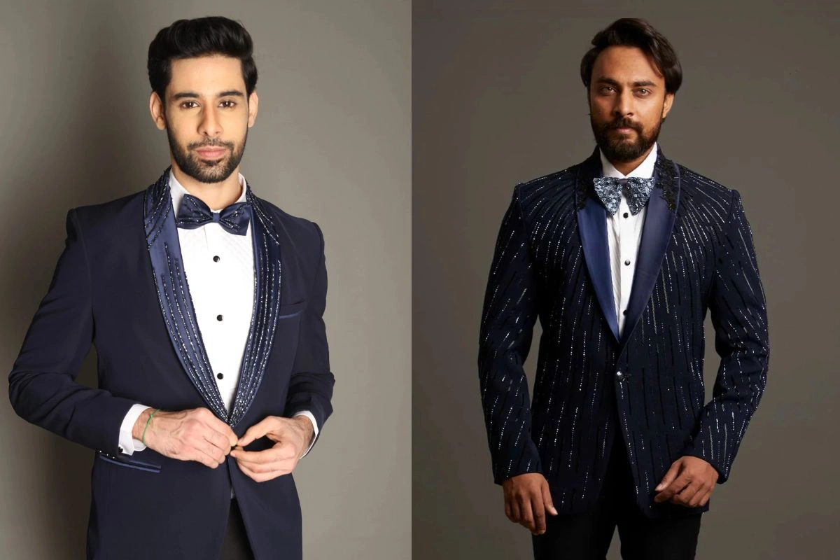 Two men modeling dark blue formal suits; one features a shiny lapel and bow tie, the other with vertical striped patterns. Perfect guide for choosing a blue suit combination for formal occasions.